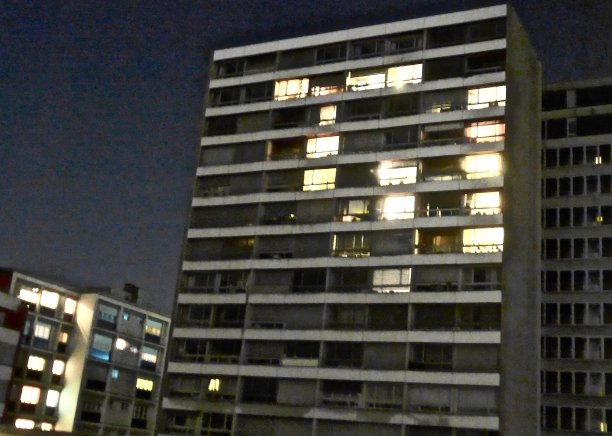 在瑞士洛桑，现代高层公寓的窗户在夜晚闪闪发光图片下载