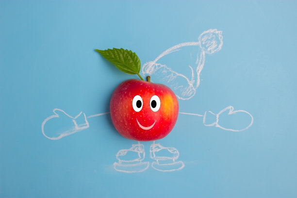 圣诞饮食概念形象。蓝色背景上的苹果图片下载