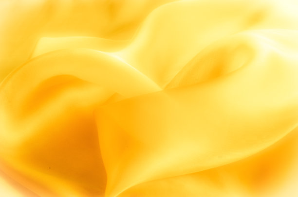 照片模糊了。质地、背景、模式。黄色丝绸织物。抽象的背景豪华蓝色织物或液体波或波浪垃圾纹理。整个背景。图片下载