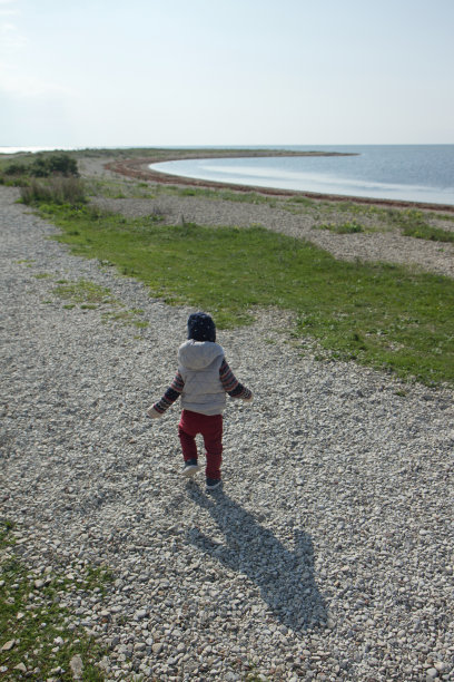 男孩在海滩上散步图片下载