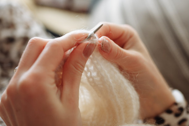 那个女人用手织毛线衣服。编织针。特写镜头。天然羊毛。水平的照片。自由职业，有创意的工作和生活理念图片下载