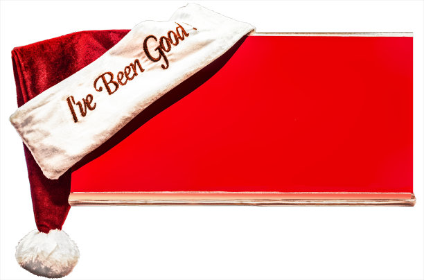 圣诞老人的帽子与字-我一直很好-栖息在角落的红色板与空间的拷贝孤立在白色的背景图片下载
