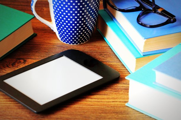 电子书阅读器和木制书籍背景。教育背景图片下载