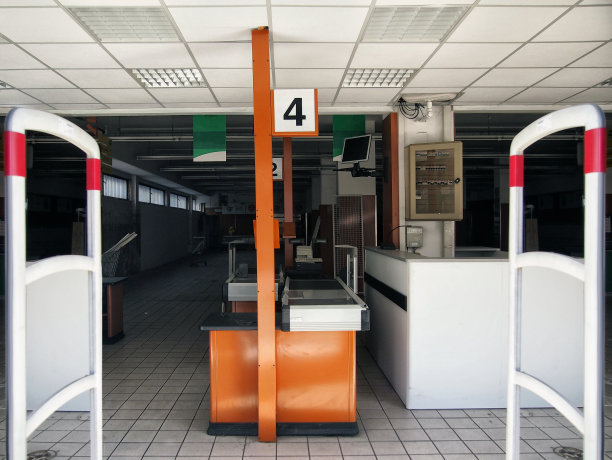 一个空荡荡的废弃的超市内部，空荡荡的货架图片下载