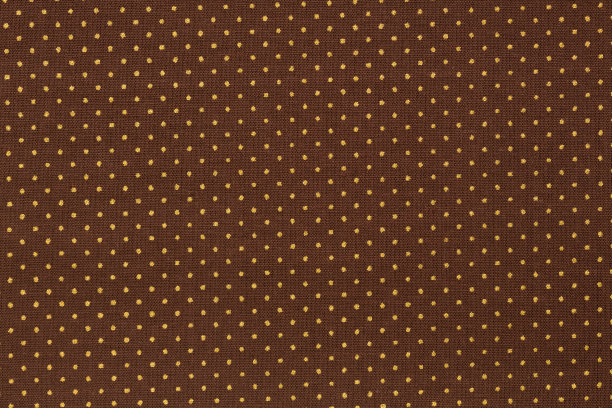 棕色织物背景和纹理上的白点。图片下载