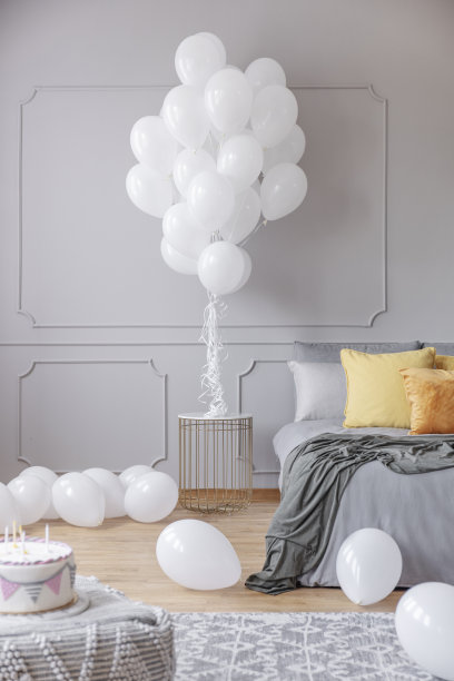 在卧室的桌子和地板上放气球。真实的照片图片下载