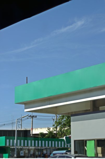 加油站和超市的绿色徽章明亮的天空背景图片下载