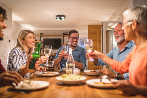 愉快的人们在晚宴上举杯庆祝图片下载