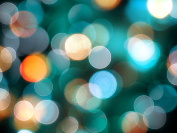 圆形明亮模糊的蓝色和橙色圆形灯上的黑色政党背景图片下载