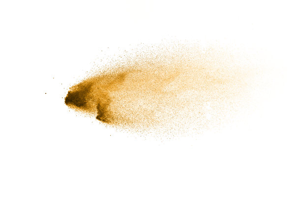 干河沙爆炸。金色的沙子溅在白色的背景上。图片下载