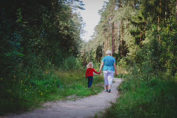 老祖母带着小孙女在大自然中漫步图片下载
