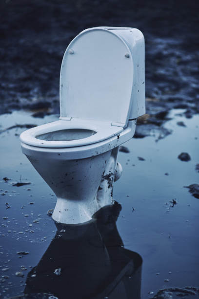 关上肮脏的抽水马桶站在水坑里图片下载