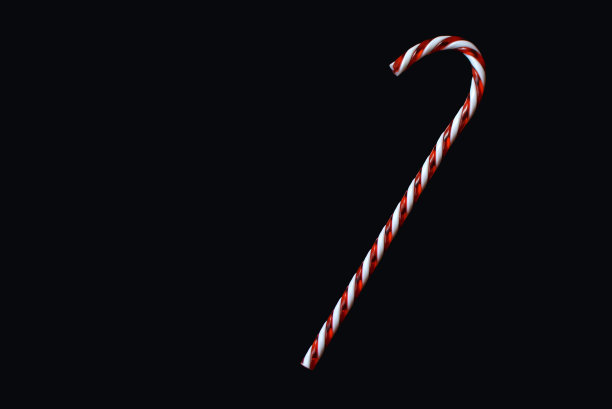 黑色背景上的圣诞糖果手杖图片下载