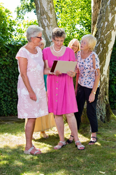 一群年长的女士在看照片。图片下载