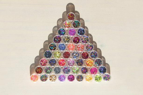 多色亮片设计的钉子在一个罐子。在jar闪闪发光。指甲用锡箔。组照片。闪闪美丽，闪闪发光。明亮的背景闪着一个三角形。顶级竞争图片下载