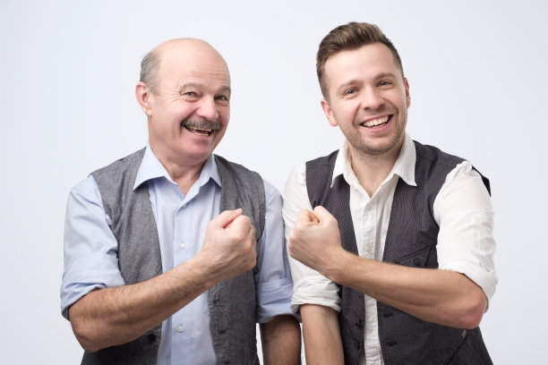 两个快乐的伙伴穿着衬衫和背心微笑和显示fis图片下载