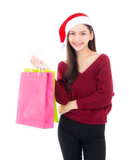 快乐时尚亚洲女人与微笑拿着购物纸袋和信用卡，销售和圣诞节与假日，女孩与买家享受和兴奋孤立在白色的背景，季节概念。图片下载