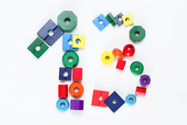 俯视图一个由数字问号组成的儿童玩具积木，平躺在白色的背景上图片下载