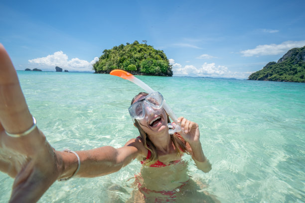 浮潜女孩自拍在热带岛屿上享受海滩假期图片下载