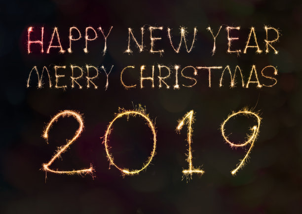 新年快乐2019手写的文字在夜晚闪烁着五彩缤纷的烟花图片下载