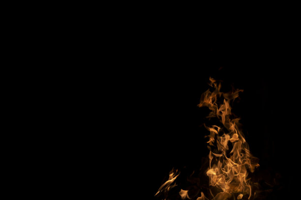 火焰火焰在抽象艺术黑色的背景上，燃烧着的红色炽热的火花从巨大的火焰中升起，火红的橙色发光图片下载