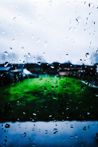 庭院和花园透过一个下雨的窗户图片下载