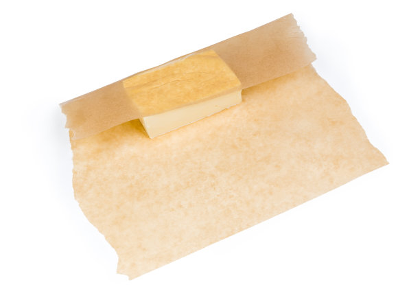 一块固体黄油，部分用蜡纸包着图片下载