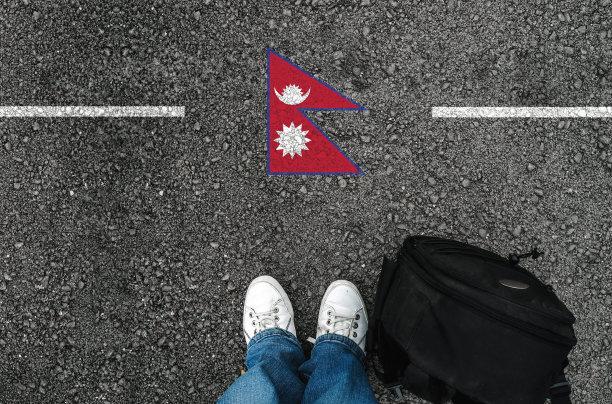 一个穿着鞋子，举着尼泊尔国旗的人图片下载