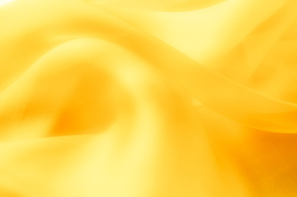 照片模糊了。质地、背景、模式。黄色丝绸织物。抽象的背景豪华蓝色织物或液体波或波浪垃圾纹理。整个背景。图片下载