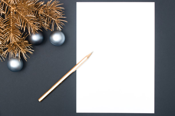 创意装饰图案与金色的圣诞树树枝，银色的小玩意和铅笔与复制空间图片下载