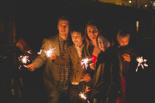 腰上的肖像，幸福的家庭一起庆祝新年和照明烟花户外图片下载