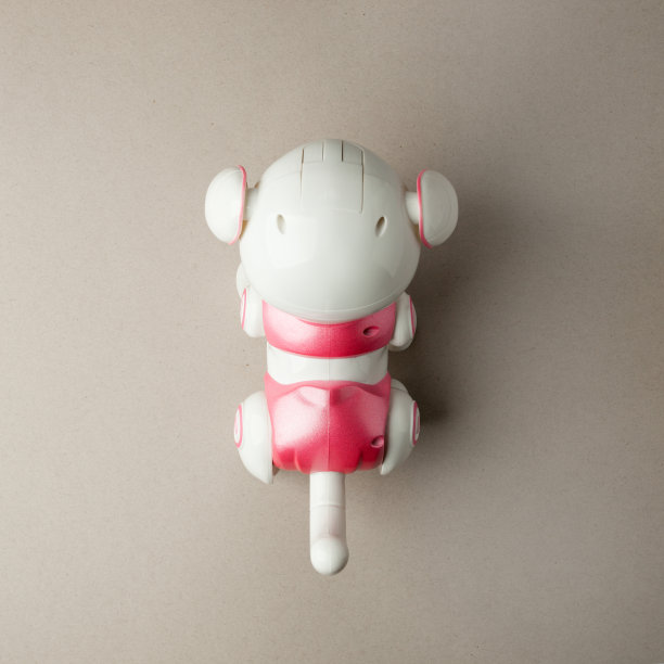 电子互动玩具小狗狗灰色背景，高科技概念，未来的宠物，电子家居，平躺，俯视图图片下载