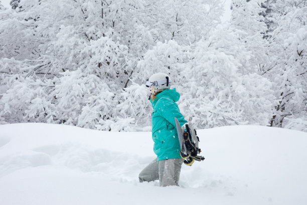 女孩带着滑雪板在深雪中行走图片下载