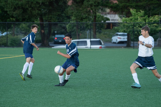 民族足球运动员在比赛中寻找队友传球图片下载