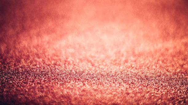 抽象闪亮的珊瑚色纹理与散景模糊。图片下载