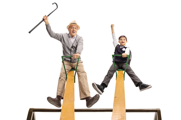 快乐的爷爷和他的孙子在跷跷板上玩得很开心图片下载