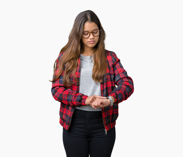 年轻美丽的黑发女子穿着夹克和眼镜在孤立的背景下查看手表上的时间，放松和自信图片下载