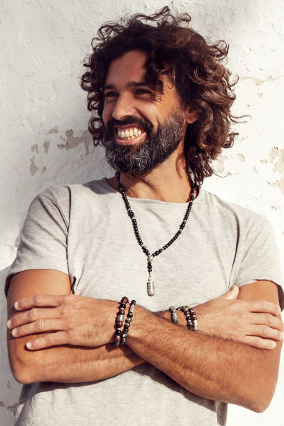 英俊的微笑时尚的男人穿着灰色的衬衫和摆姿势在户外图片下载