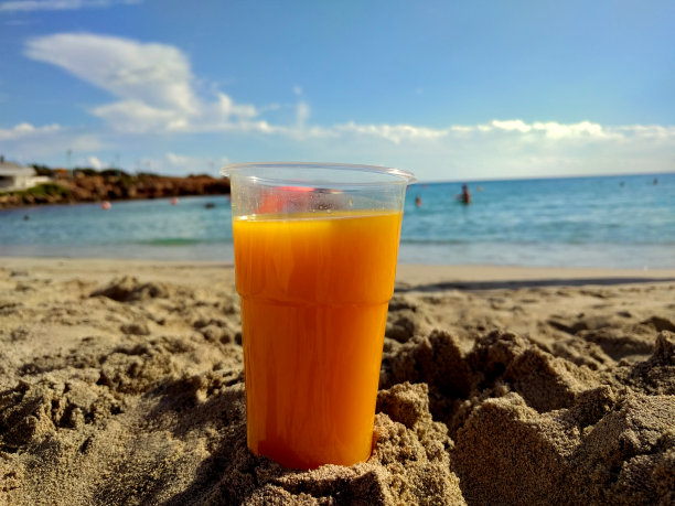 海滩上的新鲜橙杯图片下载