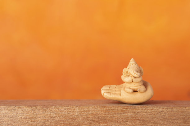 快乐的微笑大象陶土雕塑在手图片下载