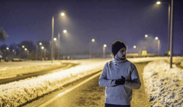 一个爱好运动的年轻人在寒冷的冬夜准备锻炼。图片下载