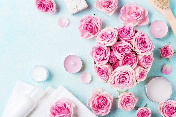 香薰，水疗，玫瑰花美容背景，化妆品和蜡烛在蓝色的桌子上。平的。图片下载