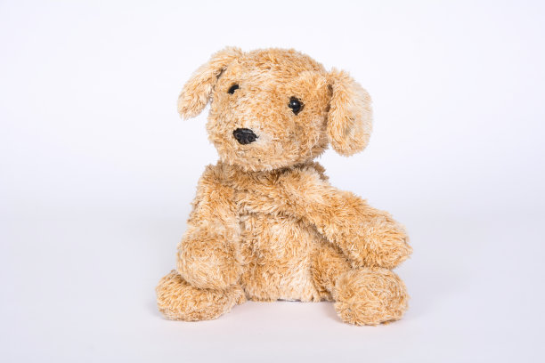 柔软的玩具狗在一个轻的背景图片下载