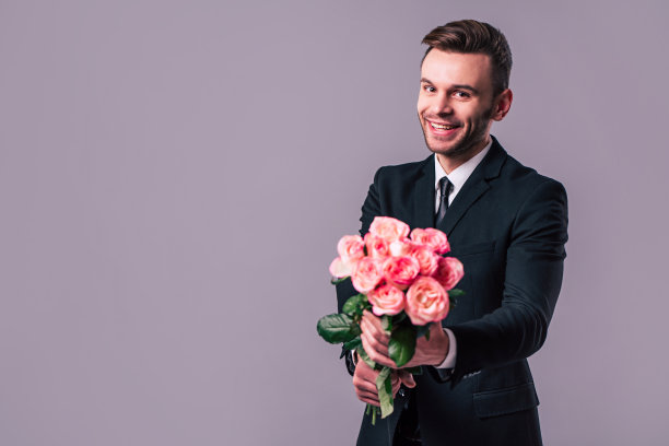 男子手捧花束的特写照片。庆祝、节日和礼物的概念。圣情人节。爱的一天图片下载