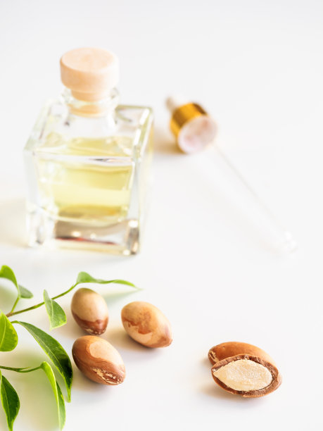装有贵重坚果油的瓶子。化妆品的意思。食品产品。在隔离的背景下放置摩洛哥坚果油图片下载
