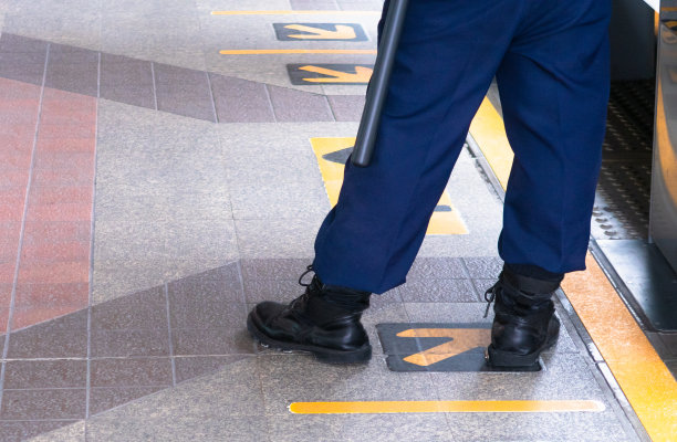 形象的后面是保安人员身后的黄线，防范危险图片下载