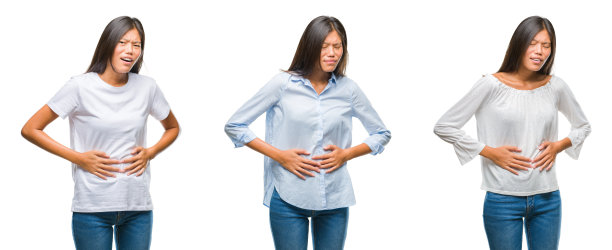 拼贴的亚洲年轻女子站在白色孤立的背景与手胃，因为消化不良，痛苦的疾病感觉不适。疼痛的概念。图片下载