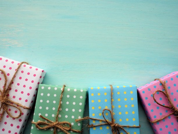 彩色的礼品盒框架与复古的浅蓝色油漆木制背景，生日和圣诞节的概念图片下载
