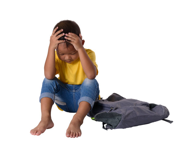 悲伤的亚洲小男孩坐在地板上背包孤立的白色背景图片下载