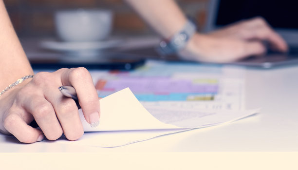 地产创意工作室办公室。女建筑师从事建筑项目的室内设计。女人的手越过画着画的桌子。图片下载